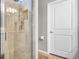 Modern shower with tiled walls, glass door, and built-in shelving at 19437 Ship Wheel Way, Land O Lakes, FL 34638