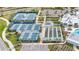 Aerial view of tennis and bocce ball courts featuring blue courts and manicured grounds at 19437 Ship Wheel Way, Land O Lakes, FL 34638