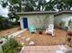 Well-maintained backyard with a detached garage, seating, and stone pathway at 208 W Amelia Ave # 1, Tampa, FL 33602