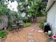 Relaxing backyard with seating, a stone pathway, mature trees, and a grill at 208 W Amelia Ave # 1, Tampa, FL 33602