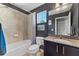 Bathroom features a shower over bath combination, granite countertop, vanity, and a window at 208 W Amelia Ave # 1, Tampa, FL 33602