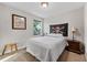 Bedroom features a decorative skull tapestry, double bed, small side table, and a window that provides natural light at 208 W Amelia Ave # 1, Tampa, FL 33602