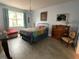 Inviting bedroom featuring a colorful bedspread, decorative chandelier, and bright window at 208 W Amelia Ave # 1, Tampa, FL 33602