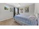 Bedroom features a double bed, neutral carpet, two windows that provide ample natural light, and modern art at 208 W Amelia Ave # 1, Tampa, FL 33602