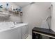 This laundry room features a washer, dryer, wire shelving, and an ironing board at 208 W Amelia Ave # 1, Tampa, FL 33602