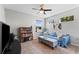 Cozy living room area with a sofa, area rug, bookcase, and a window that provides ample natural light at 208 W Amelia Ave # 1, Tampa, FL 33602