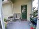 This screened porch includes outdoor seating and an entrance door to the backyard at 208 W Amelia Ave # 1, Tampa, FL 33602
