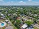 Expansive view of a neighborhood featuring many mature trees, homes, and a nearby community pool at 217 Emerald Ln, Largo, FL 33771