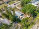 Charming home featuring a metal roof, fenced yard, canopy, and mature trees offering shade and privacy at 217 Emerald Ln, Largo, FL 33771