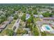 An aerial view of the home in a neighborhood with a road and surrounding trees at 217 Emerald Ln, Largo, FL 33771