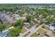 A view of the property showing mature trees, a nearby pool, and neighborhood parking at 217 Emerald Ln, Largo, FL 33771