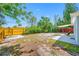 Spacious backyard featuring a wood fence, some trees and plants, and a small patio area for outdoor enjoyment at 217 Emerald Ln, Largo, FL 33771
