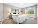 Inviting bedroom with natural light, a plush bed, and a sliding glass door to the backyard at 217 Emerald Ln, Largo, FL 33771