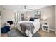 Comfortable bedroom with ceiling fan, natural light, and a connected bathroom and closet space at 217 Emerald Ln, Largo, FL 33771