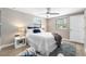 Bright bedroom features updated flooring, a ceiling fan, and two bright windows at 217 Emerald Ln, Largo, FL 33771