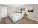Well-lit bedroom offers updated flooring, a window with blinds, and a stylish side table at 217 Emerald Ln, Largo, FL 33771