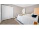 Bright bedroom features a spacious closet, wood-look flooring, and fresh neutral paint at 217 Emerald Ln, Largo, FL 33771