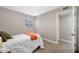 Bedroom featuring updated flooring, a bright window, and neutral paint throughout at 217 Emerald Ln, Largo, FL 33771
