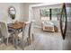 Dining area featuring a wooden table with seating for four, a window and a comfortable armchair at 217 Emerald Ln, Largo, FL 33771