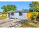 Home exterior with nice landscaping, fresh paint, and a well-manicured lawn at 217 Emerald Ln, Largo, FL 33771
