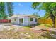 Exterior view showcasing a home with a backyard, patio, sliding glass door, and well-maintained fencing at 217 Emerald Ln, Largo, FL 33771