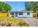 Charming single-story home features a well-manicured lawn, a classic exterior, and a vibrant yellow fence at 217 Emerald Ln, Largo, FL 33771