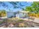 Exterior view showing the side of the house with outdoor seating and a well-kept yard at 217 Emerald Ln, Largo, FL 33771