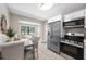 Open-concept kitchen with stainless steel appliances, dining area, and view to the living room at 217 Emerald Ln, Largo, FL 33771