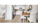 Bright kitchen with stainless steel appliances and adjacent dining area with seating for four at 217 Emerald Ln, Largo, FL 33771