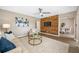 The inviting living room features modern decor, a ceiling fan, wood accent wall, and a glimpse of the dining area at 217 Emerald Ln, Largo, FL 33771