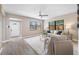Bright living room with a ceiling fan, modern furniture, stylish decor, and a decorative front door at 217 Emerald Ln, Largo, FL 33771