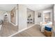 Bright, spacious living room flows into a dining area and features wood-look flooring and a rustic wood accent wall at 217 Emerald Ln, Largo, FL 33771