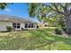 Large back yard with mature trees and lush green grass at 2222 Mayfield Palms Ln # 322, Sun City Center, FL 33573