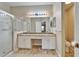 Updated bathroom with dual sinks, granite countertop, walk-in shower, and tile flooring at 2222 Mayfield Palms Ln # 322, Sun City Center, FL 33573