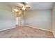 Large bedroom with neutral carpet, ceiling fan, closet, and ensuite bathroom at 2222 Mayfield Palms Ln # 322, Sun City Center, FL 33573