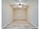Bedroom with a ceiling fan, neutral paint, and wood-look tile flooring at 2222 Mayfield Palms Ln # 322, Sun City Center, FL 33573