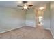 Spacious bedroom with neutral carpet, ceiling fan, closet, and ensuite bathroom at 2222 Mayfield Palms Ln # 322, Sun City Center, FL 33573