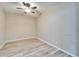 Cozy bedroom with wood-look tile flooring, ceiling fan, and neutral wall color at 2222 Mayfield Palms Ln # 322, Sun City Center, FL 33573