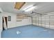 View of the large garage with painted floor and storage shelves at 2222 Mayfield Palms Ln # 322, Sun City Center, FL 33573
