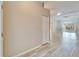 Neutral hallway with wood-look tile flooring leading into a spacious living area at 2222 Mayfield Palms Ln # 322, Sun City Center, FL 33573