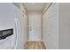 Hallway view featuring white doors and wood-look floors at 2222 Mayfield Palms Ln # 322, Sun City Center, FL 33573
