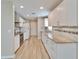Modern kitchen with white cabinets, granite counters, tile backsplash, and stainless steel appliances at 2222 Mayfield Palms Ln # 322, Sun City Center, FL 33573