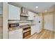 Modern kitchen features stainless steel appliances, granite countertops, and sleek white cabinetry at 2222 Mayfield Palms Ln # 322, Sun City Center, FL 33573