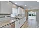 Bright kitchen with stainless steel appliances, granite counters, updated cabinets, and wood-look tile at 2222 Mayfield Palms Ln # 322, Sun City Center, FL 33573