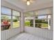 Enclosed lanai with tile flooring and multiple windows offering natural light and backyard views at 2222 Mayfield Palms Ln # 322, Sun City Center, FL 33573
