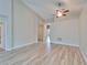 Spacious living room featuring high ceilings, wood-look flooring, and neutral color palette at 2222 Mayfield Palms Ln # 322, Sun City Center, FL 33573