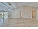 Spacious living room with high ceilings, wood-look tile flooring, and sliding door to lanai at 2222 Mayfield Palms Ln # 322, Sun City Center, FL 33573