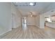 Open-concept living room with wood-look tile flooring, high ceilings, and ample natural light at 2222 Mayfield Palms Ln # 322, Sun City Center, FL 33573