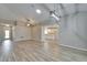 Open floor plan showcasing wood-look tile, neutral walls, modern lighting, and ample natural light at 2222 Mayfield Palms Ln # 322, Sun City Center, FL 33573