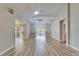 Spacious living room with wood-look tile flooring, neutral paint, and sliding glass doors to the lanai at 2222 Mayfield Palms Ln # 322, Sun City Center, FL 33573
